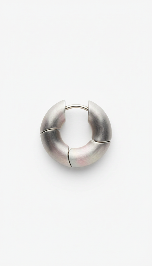 Brushed steel modular hoop earrings, Default: 3/4 angle with product elevated on matte geometric prop (block or arch) in...