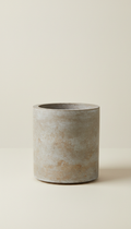 Stone Grey Cylindrical Planter, Default angle is a hero 3/4 view capturing both profile and opening of the vessel; camera...