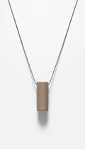 Urban taupe minimalist pendant necklace, Default: 3/4 angle shots on stone beige or muted steel textured surfaces for...