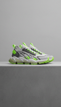 A pair of contemporary urban footwear is centered on a neutral concrete surface. The shoes are illuminated with even,...