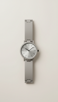 Ceramic minimalist watch, Default is a three-quarter angle highlighting the watch face and band curvature, positioned on a...