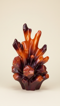 An intricately designed resin home decor item is placed centrally against a simple, highlighting its bespoke artistry....